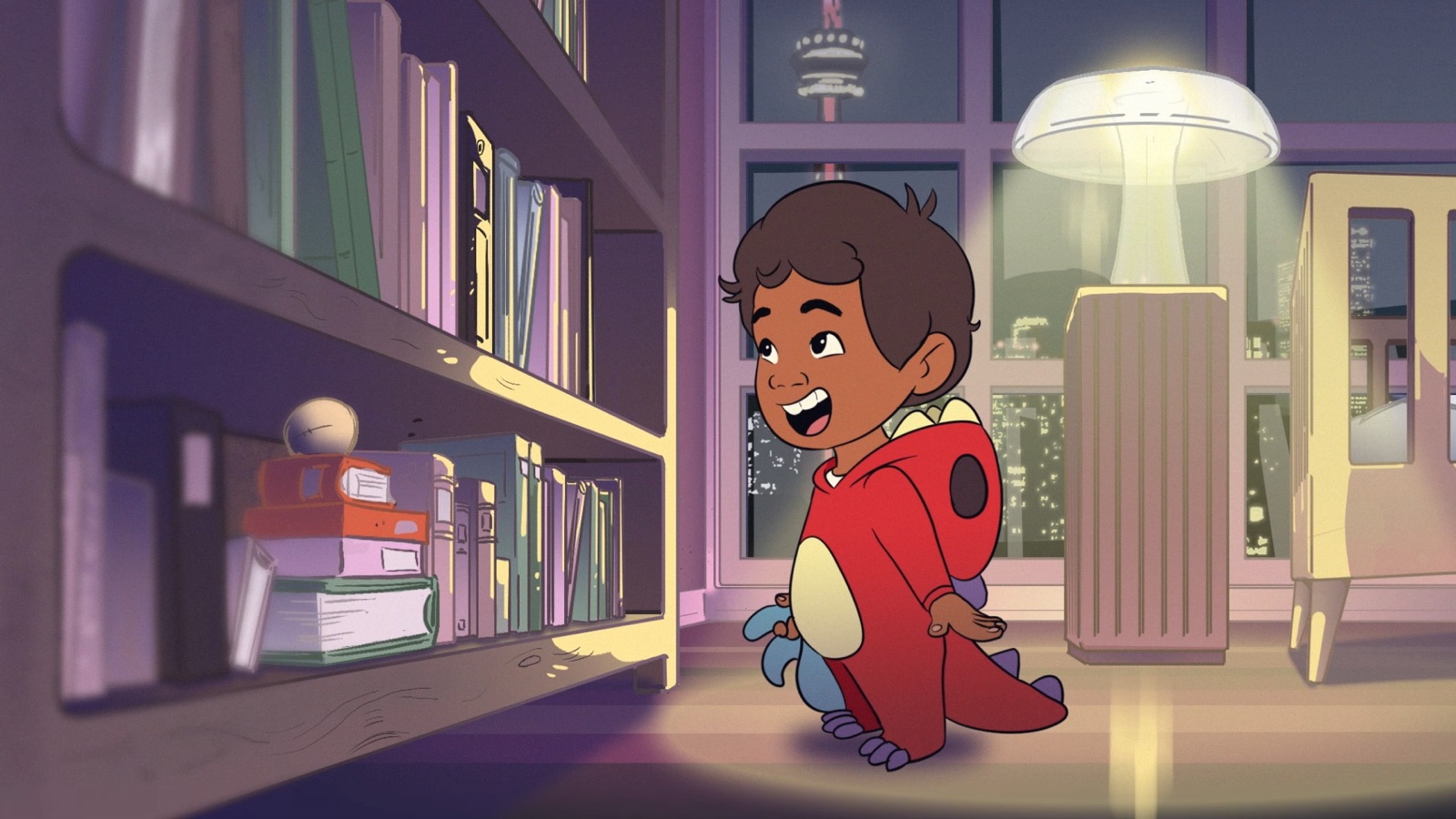 Sebbi laughing at the bookshelf